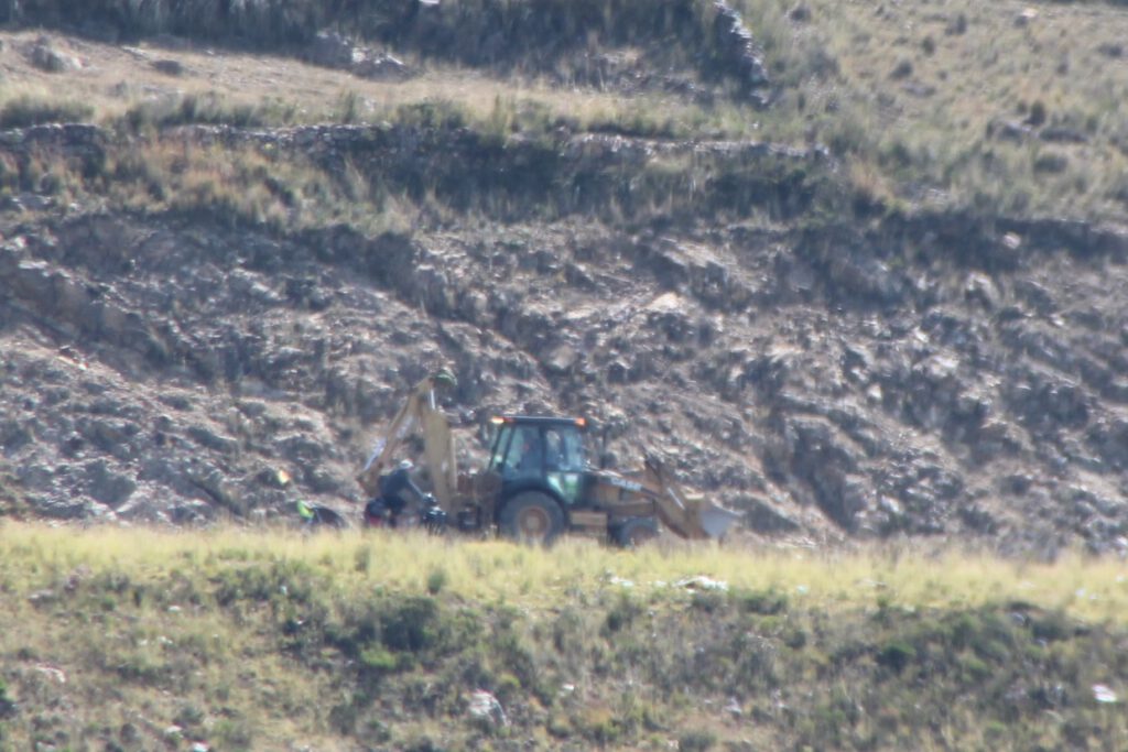 Excavator climb out of Tiquina