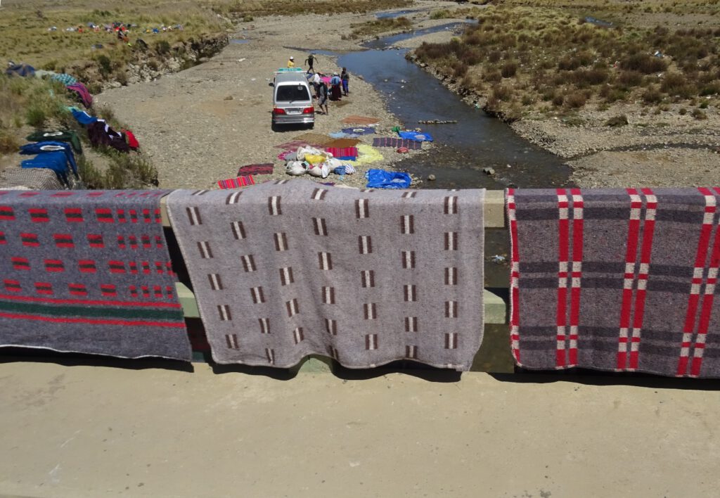 Washing cars, blankets and clothes in the nearby river